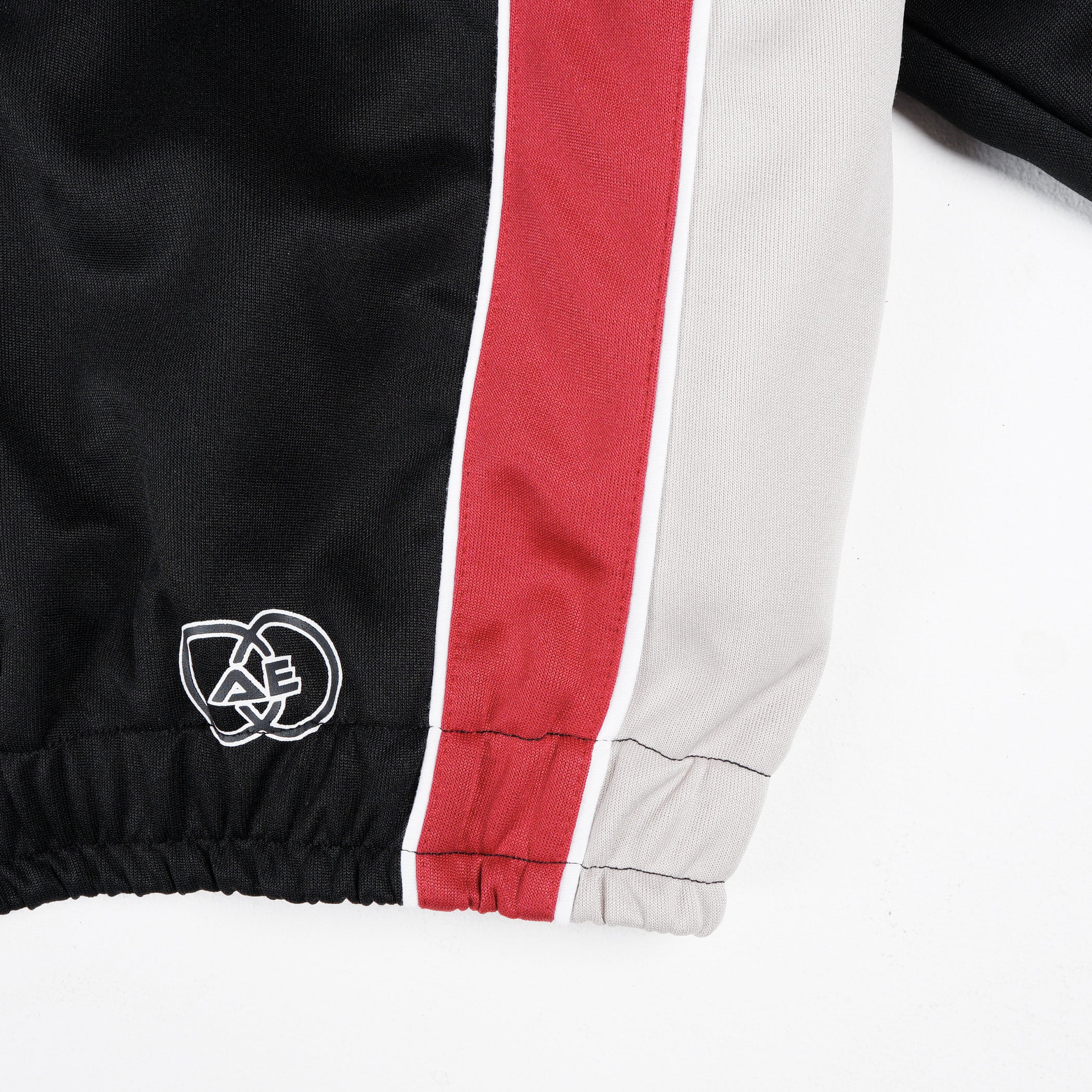 W.Essentiels x Alter Ego Darkpact Tracktop Black/Crimson